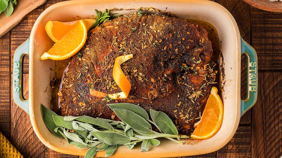 A smoked turkey breast in a baking dish.