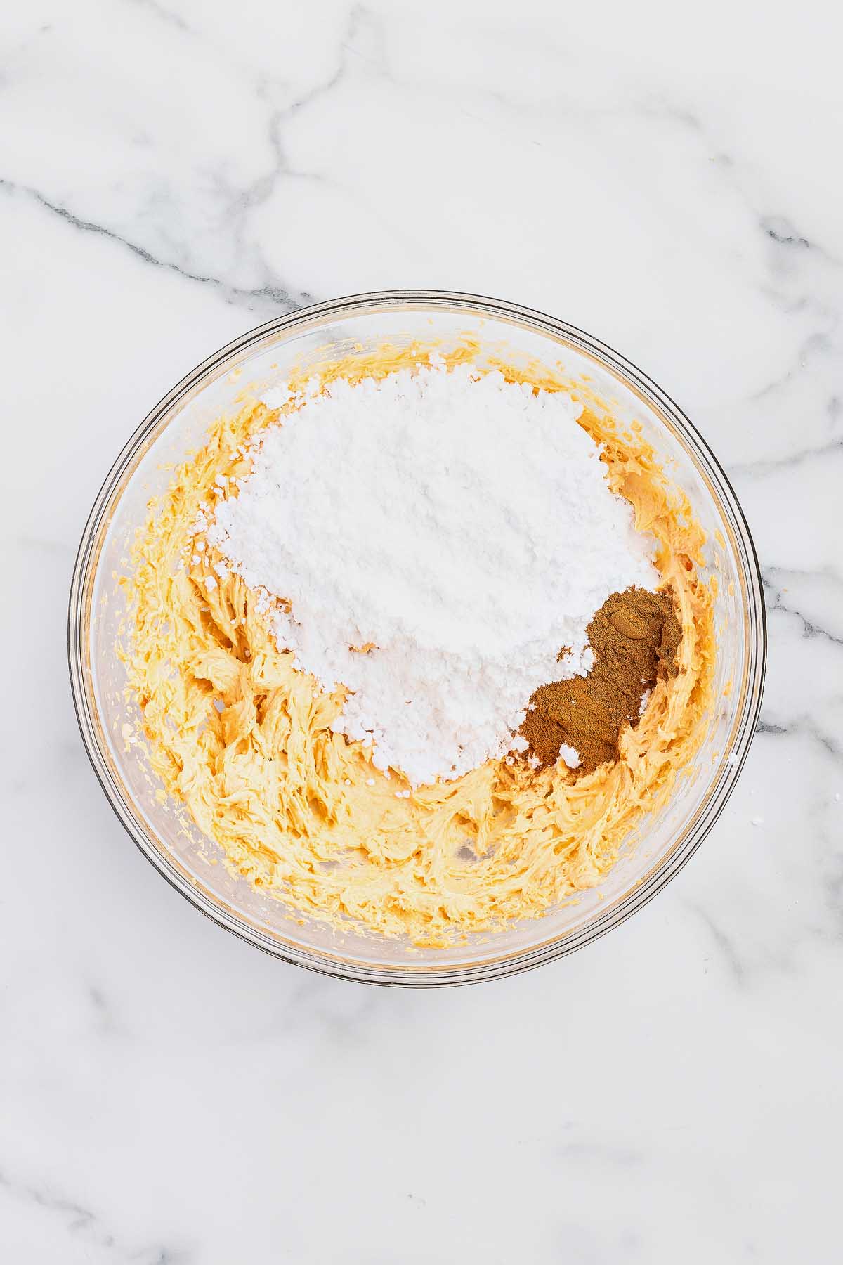 A bowl with flour, sugar, and butter in it, perfect for making cookies.