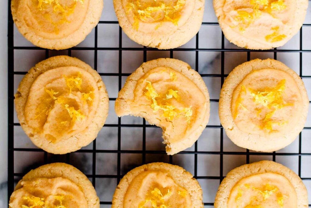 Gluten-free lemon cookies beautifully arranged on a cooling rack.