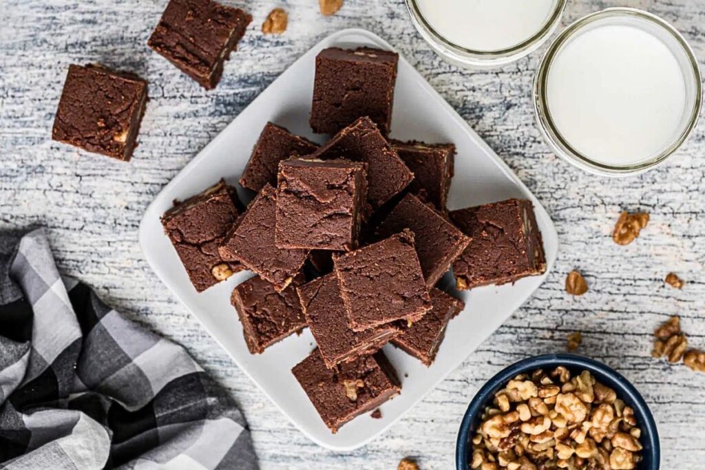 A plate of chocolate fudge, cut into squares.