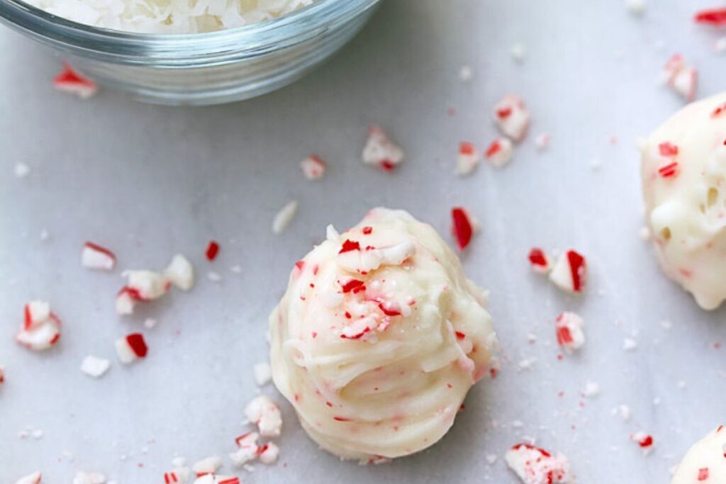 Coconut candy cane truffles with white chocolate coating and candy cane crumbs.