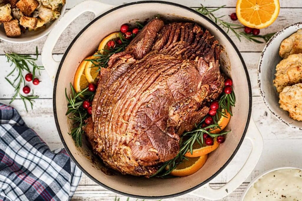 A dutch oven with glazed ham inside.