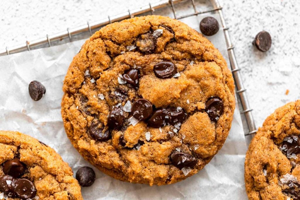Gluten-free chocolate chip cookies on a cooling rack.