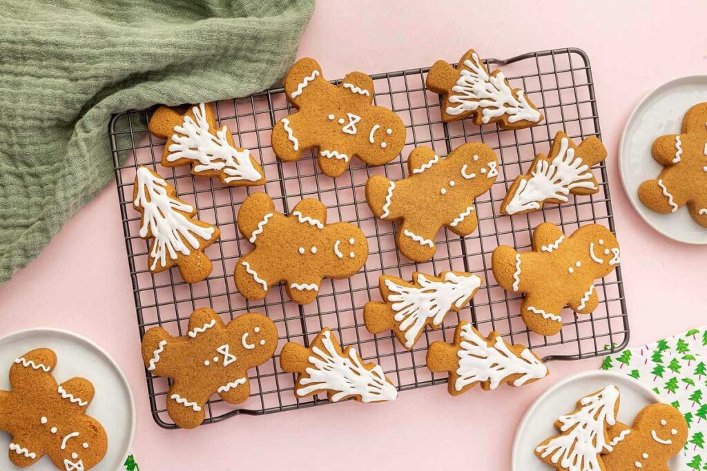 Gingerbread cookies cooling on a rack.
