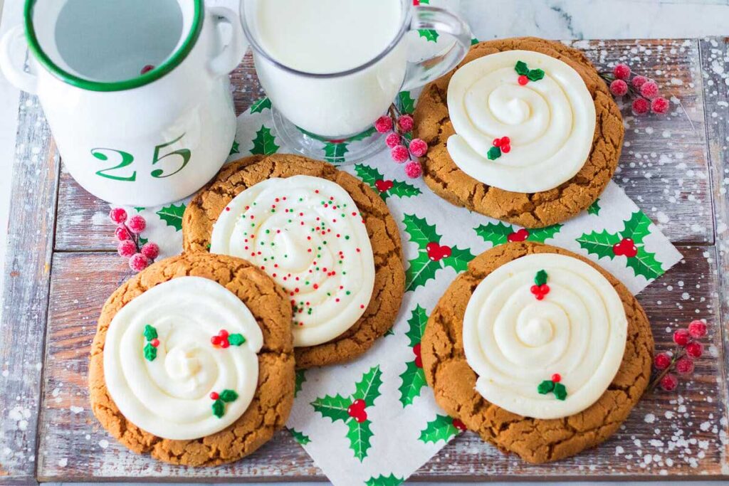 Festive gingerbread cookies with icing and holly berries.