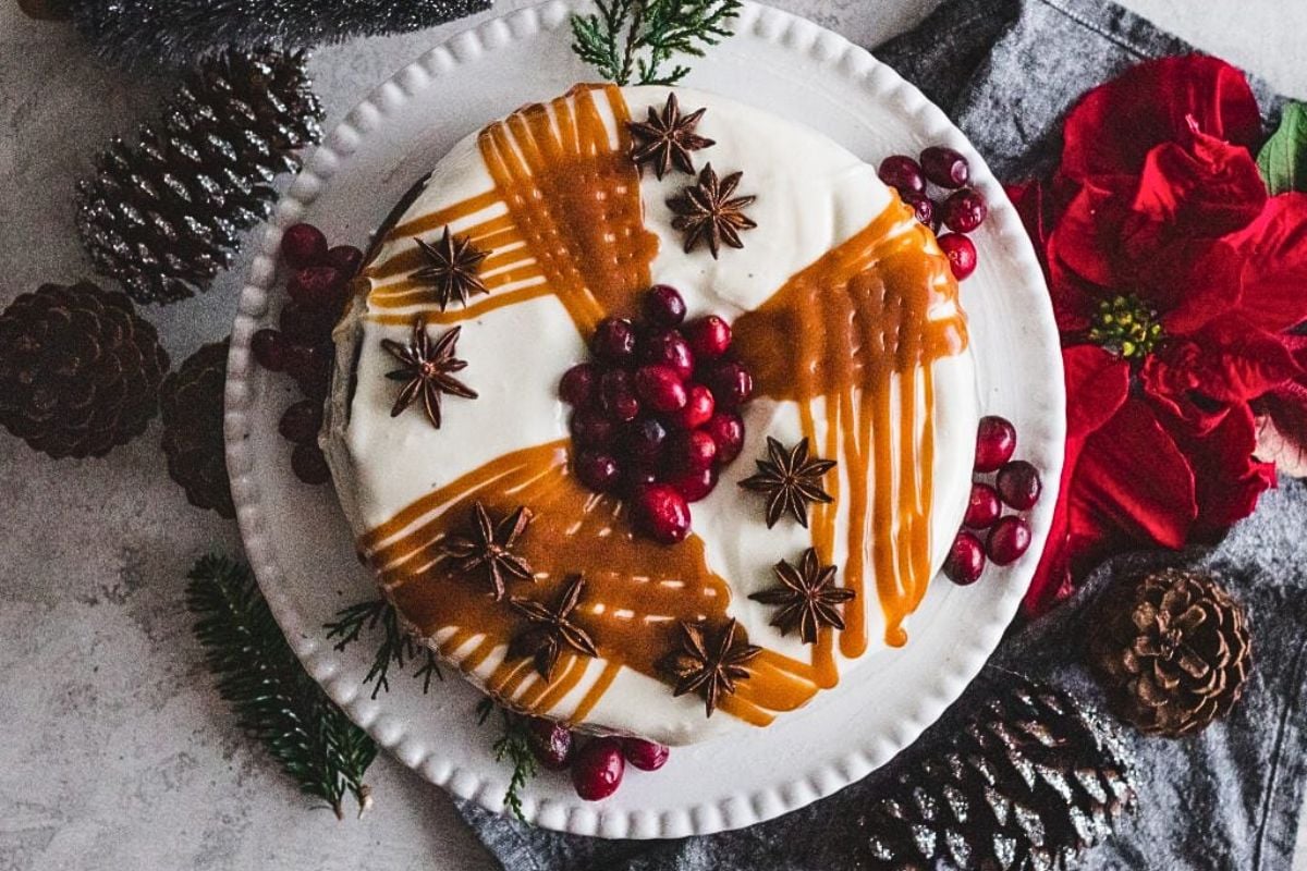 A gingerbread pound cake with cream cheese frosting, cranberries and star anise.