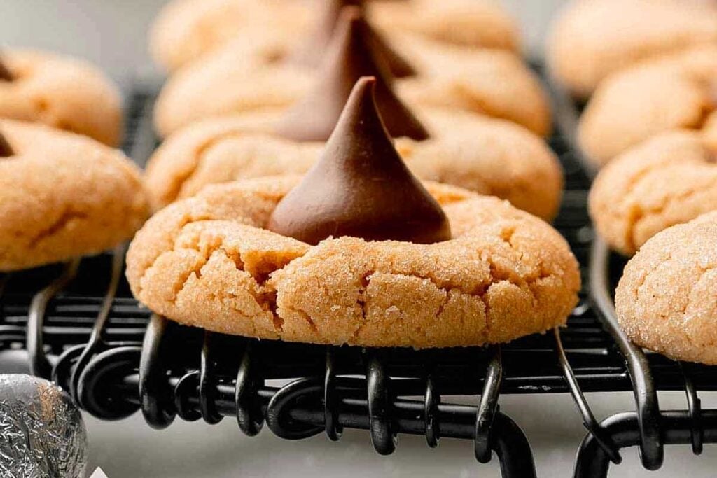Gluten free peanut butter blossom cookies cooling on a rack