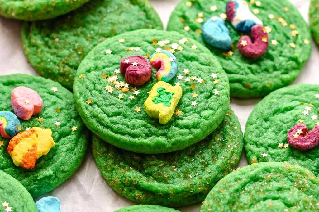 Bright green cookies topped with lucky charms and edible gold star confetti