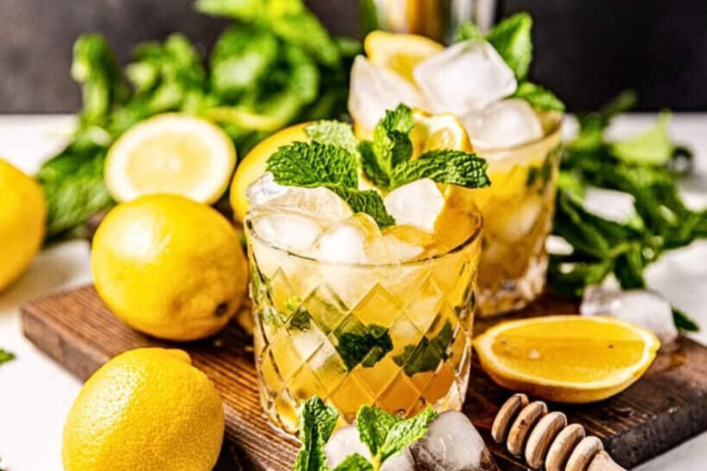 Glasses of bourbon smash cocktails with mint sprigs.