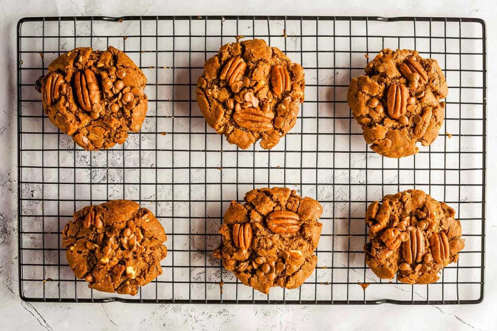 Nutty pecan cookies cooling on a rack.