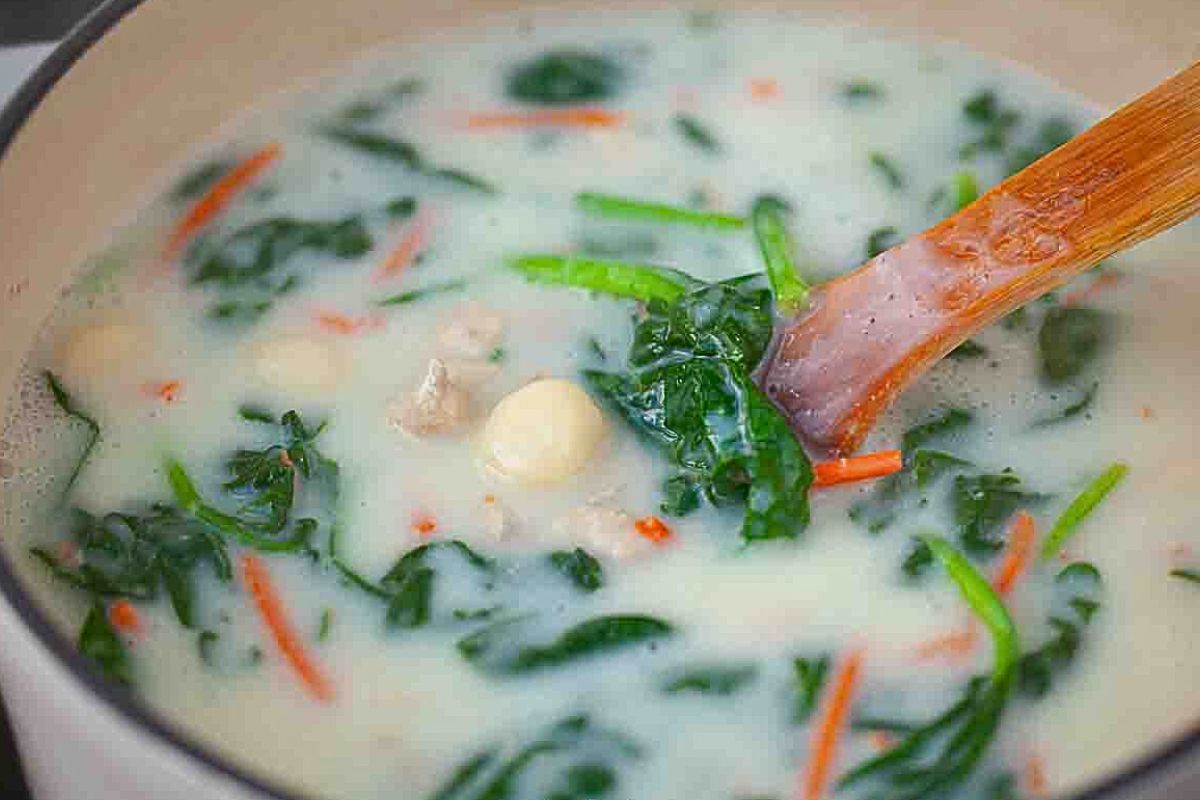 A pot of creamy chicken soup with gnocchi