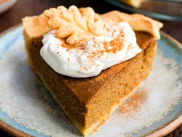 A slice of pumpkin pie on a plate.