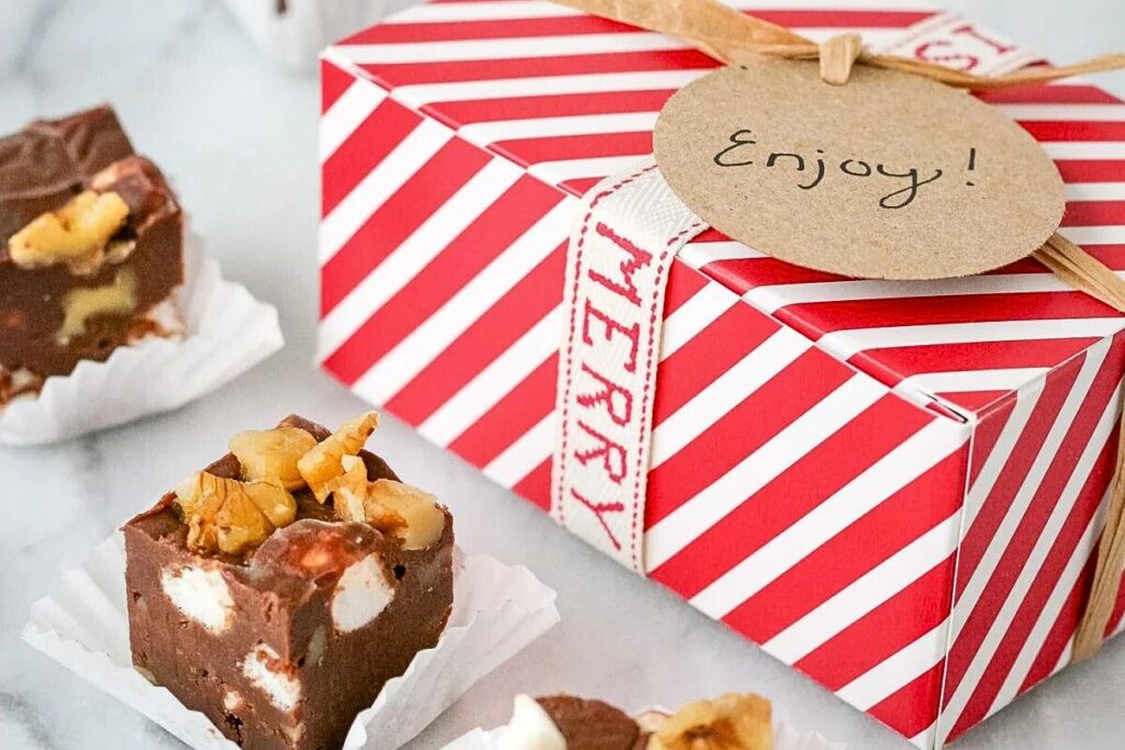Chunks of rocky road fudge near a festive gift box.