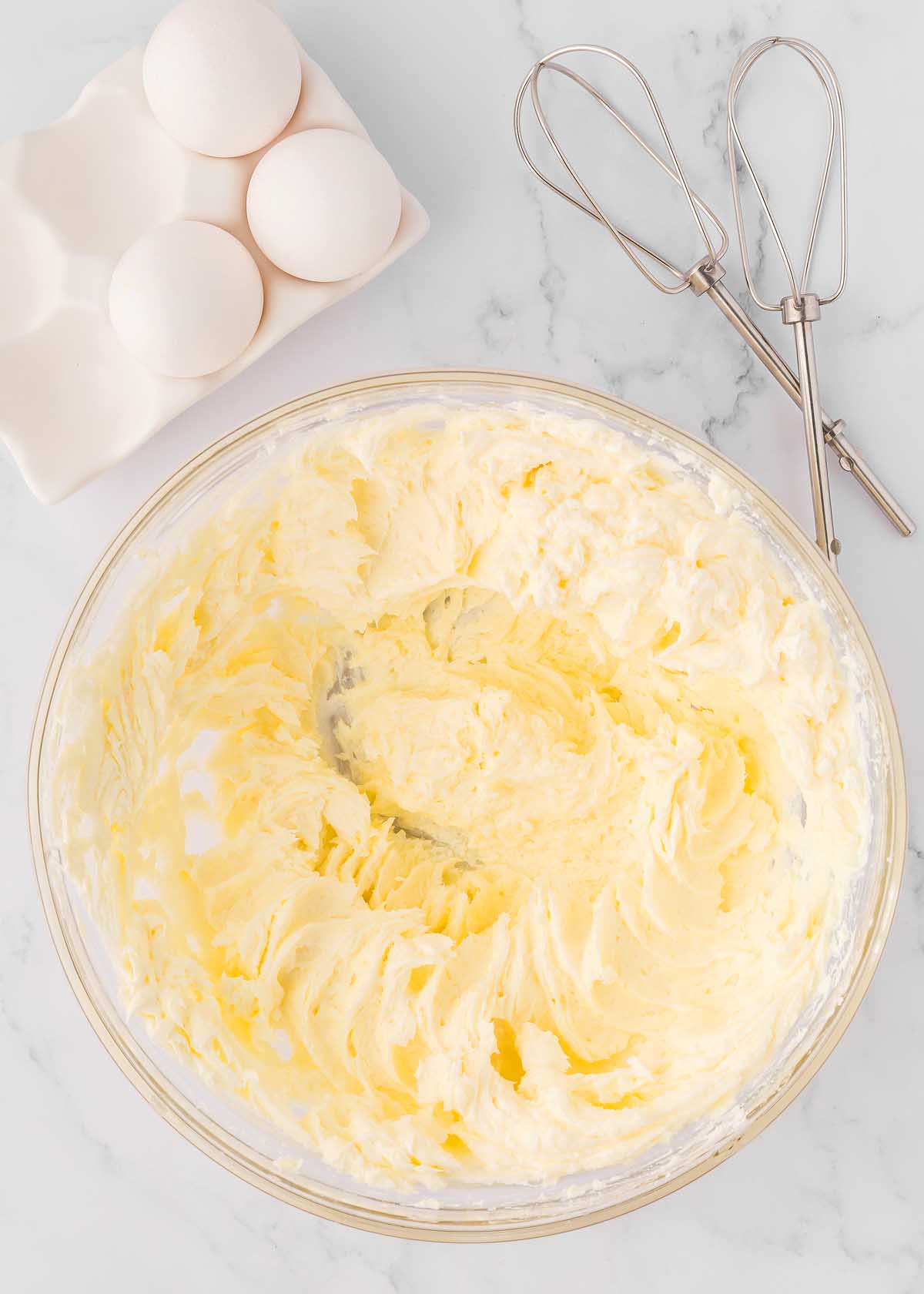 Christmas cheesecake with a gingersnap crust and eggnog cheesecake filling, displayed on a marble countertop.