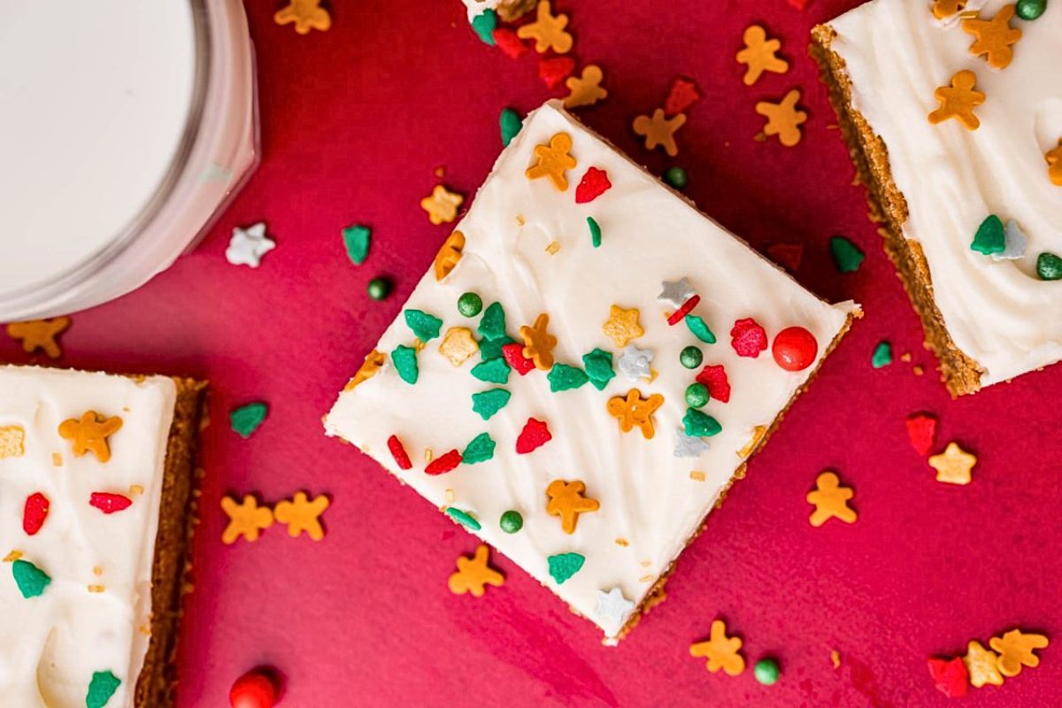 Gingerbread cookie bars with frosting and sprinkles.