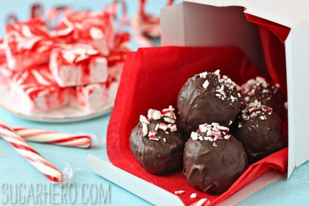A pile of hot cocoa truffle candies with peppermint marshmallow squares.