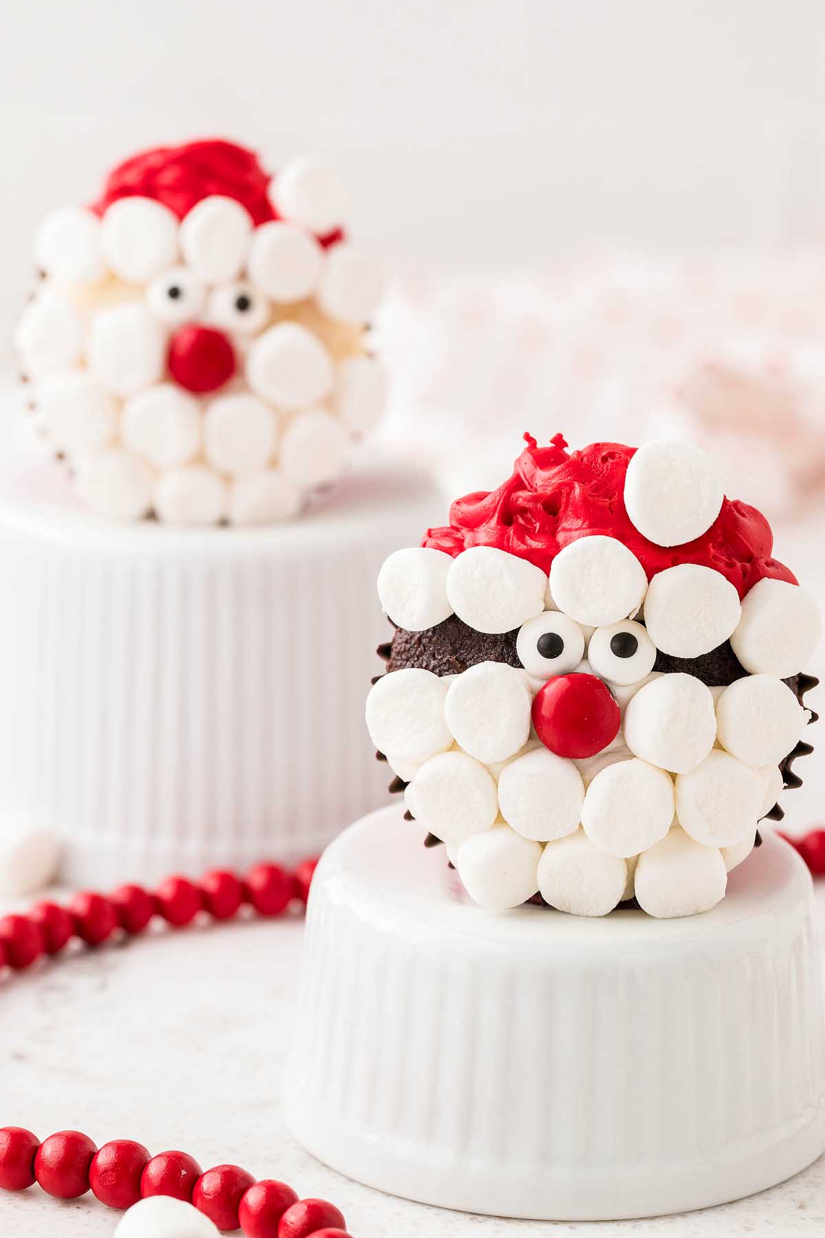 Kids will love these adorable Santa face cupcakes topped with marshmallows and candy canes.