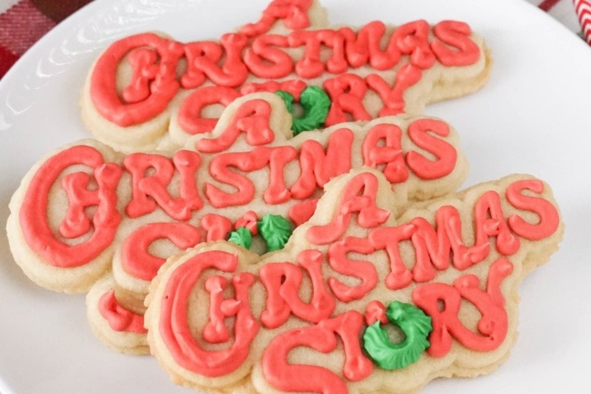 Three freezable Christmas story cookies on a plate.