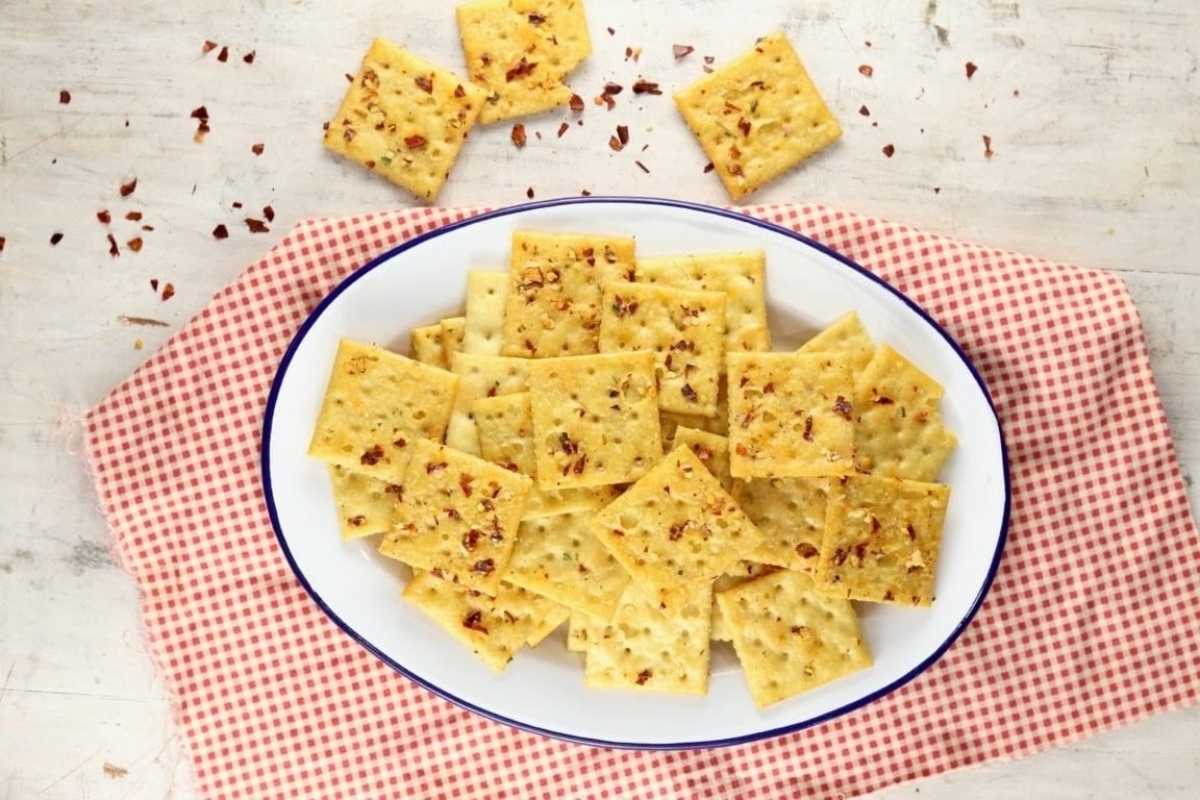 A plate of crackers on a table at a New Year's eve party, next to a checkered tablecloth.