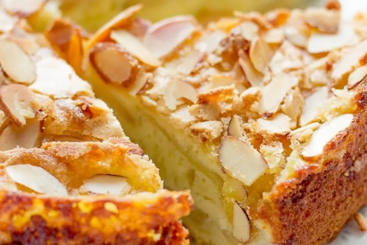A slice of almond cake on a plate, perfect for Christmas celebrations.
