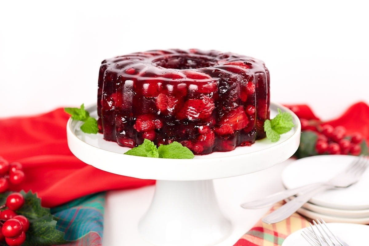 A cranberry jelly cake on a white plate, perfect for a make ahead holiday dish.