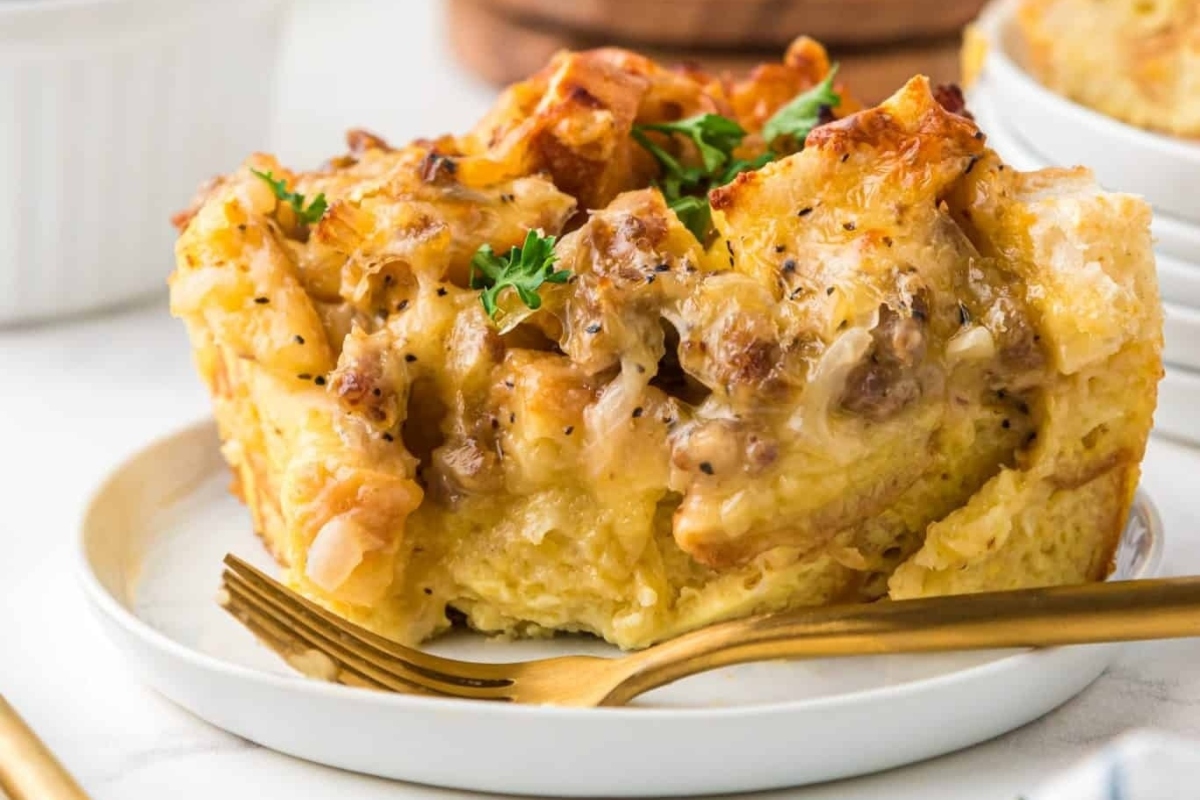 Make ahead French toast casserole on a plate with a fork, perfect for holiday dishes.