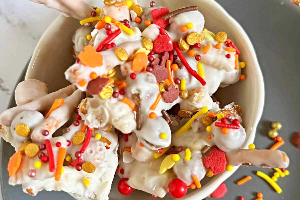 A bowl filled with candy corn and sprinkles, perfect for festive Christmas bark recipes.