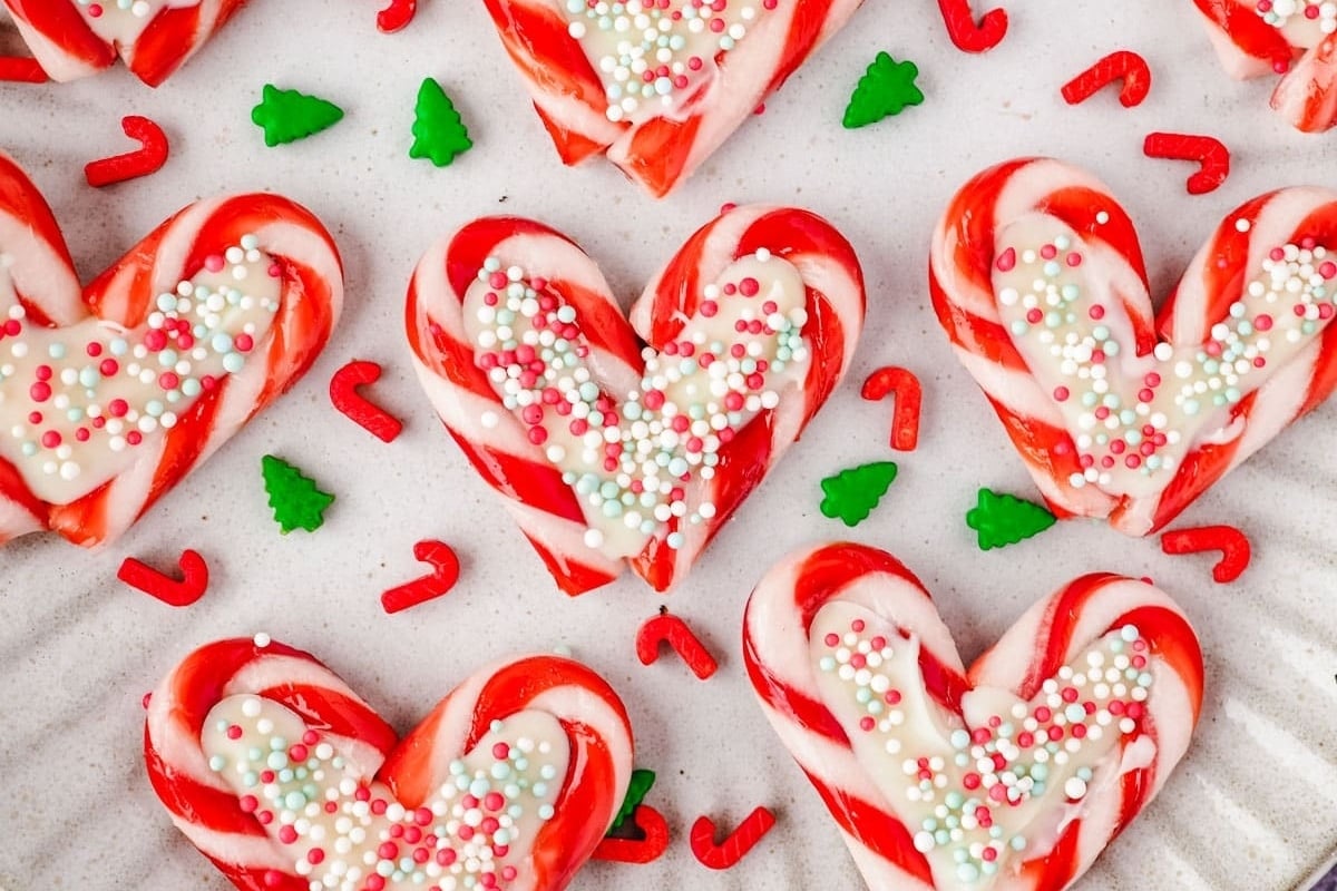 Heart shaped candy cane cookies on a plate, perfect for your upcoming holiday celebration.