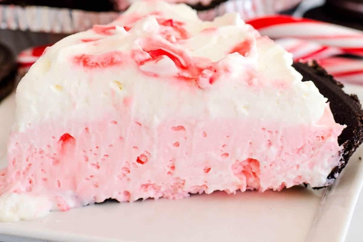 A delectable slice of candy cane ice cream pie on a plate.