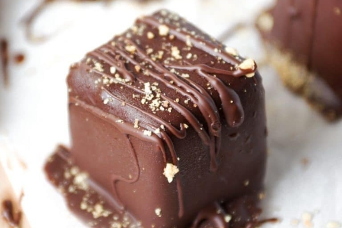 A holiday dessert featuring chocolate squares topped with a luscious drizzle of chocolate.
