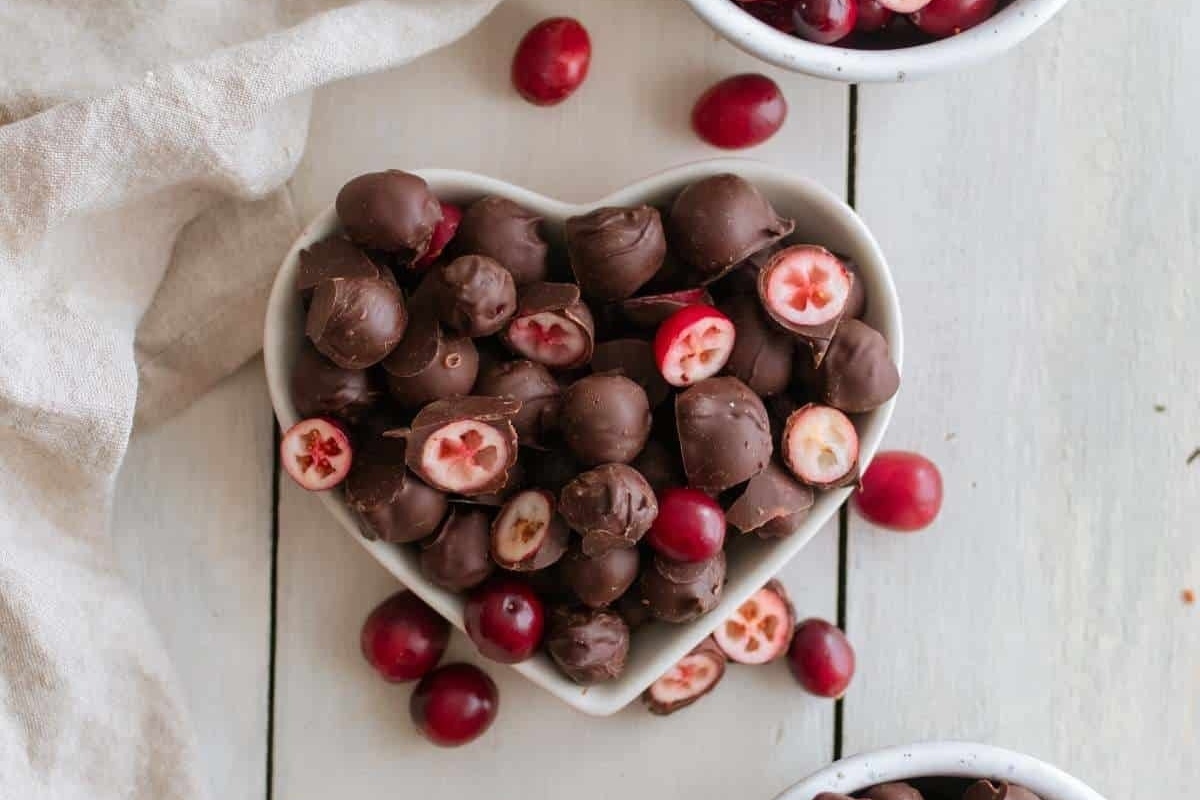 Cranberry snack recipe - chocolate covered cranberries in a heart shaped bowl.