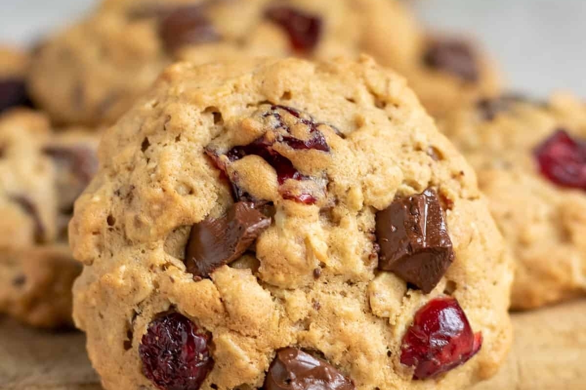 Cranberry chocolate chip cookies on a cutting board, perfect for cranberry snack lovers.