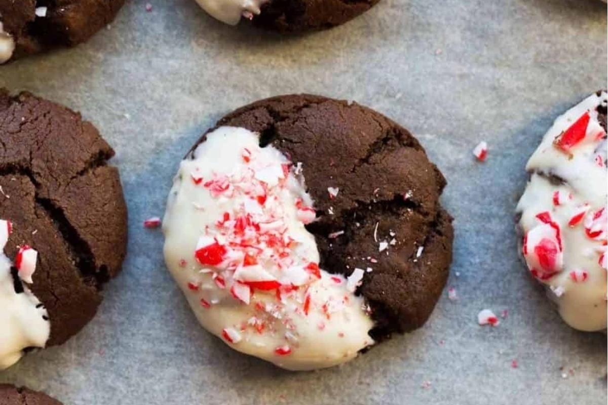 Peppermint cookies with white icing on a baking sheet.