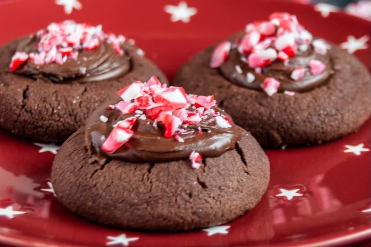 Three chocolate peppermint cookies on a red plate.