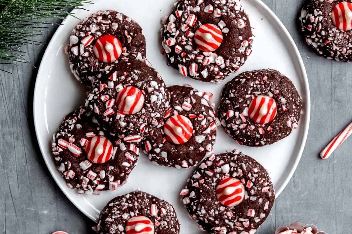 Chocolate peppermint cookies on a plate with candy canes.