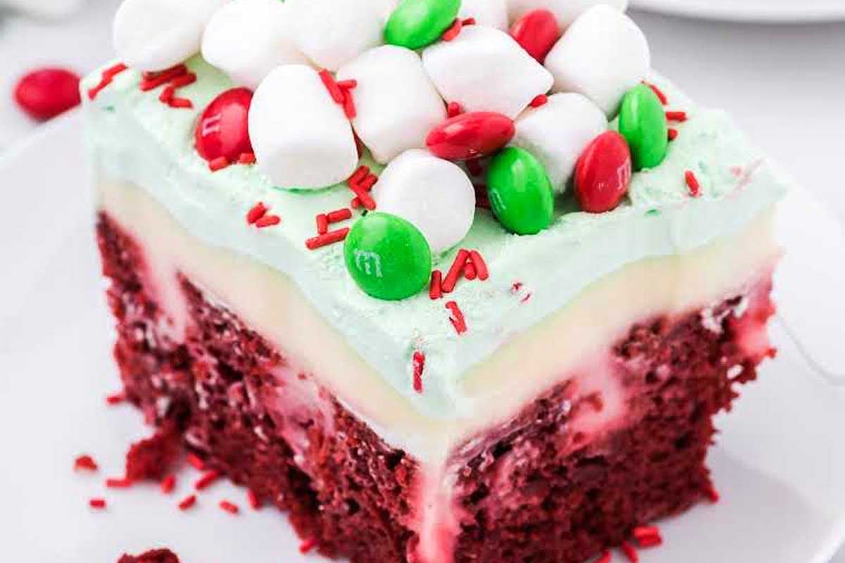 A piece of red velvet cake with marshmallows on top, perfect for indulging in a decadent cocoa treat.