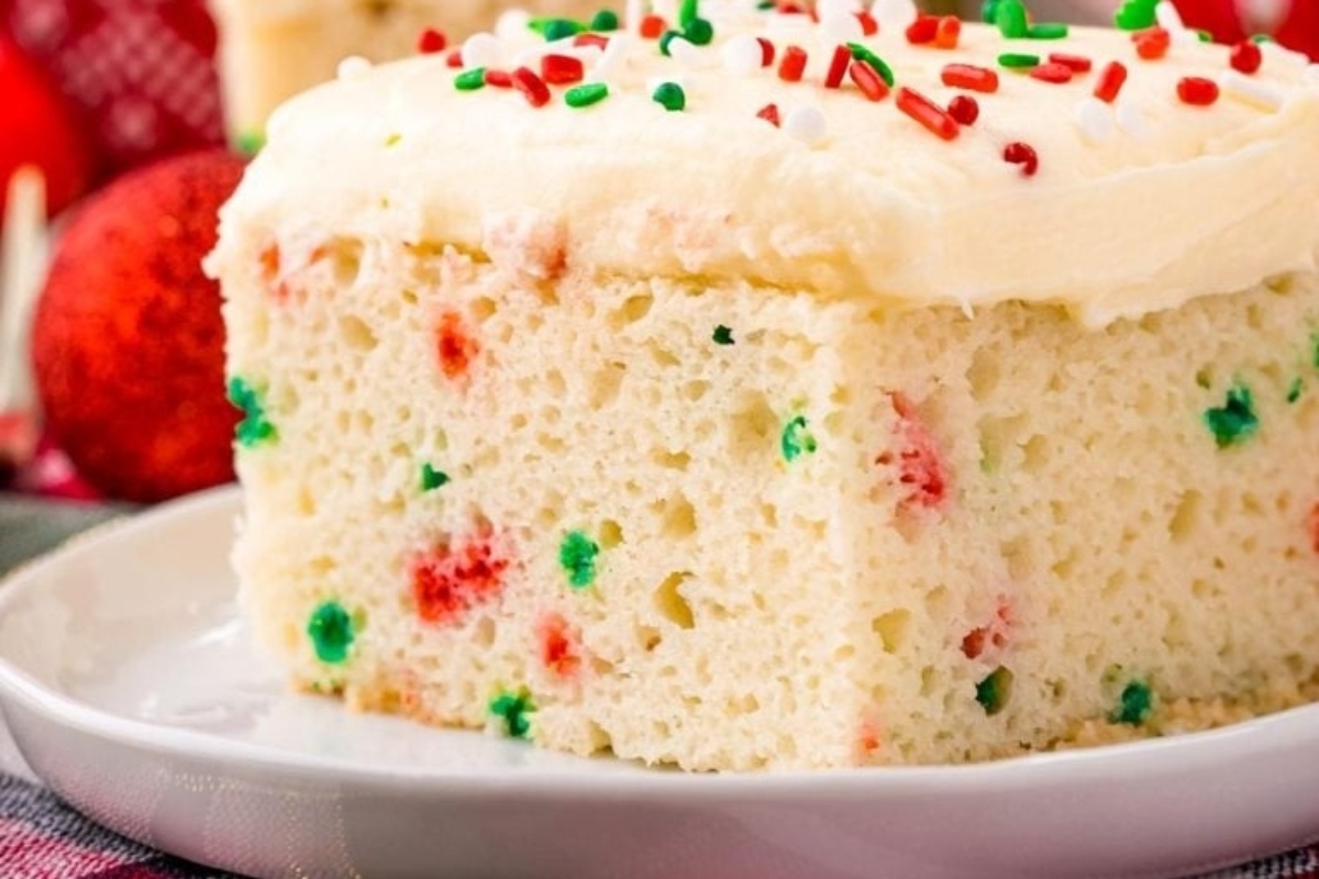 A festive Christmas cake adorned with frosting and sprinkles.