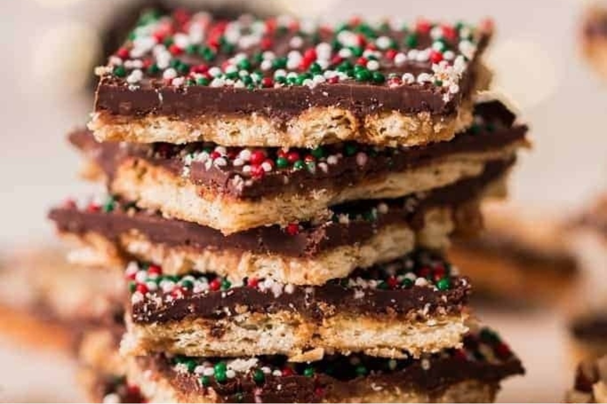 An indulgent stack of chocolate graham cracker bars with sprinkles, perfect for Christmas bark recipes.