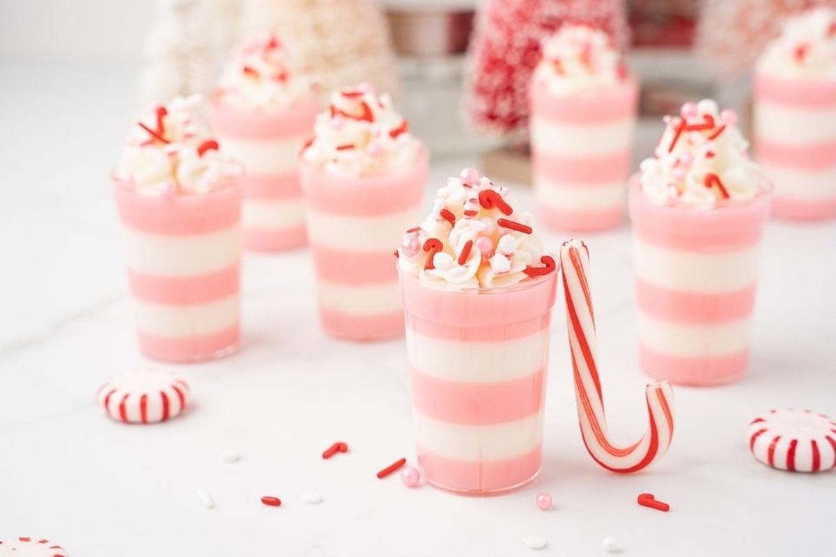 A group of pink and white cups with candy canes in them, perfect for peppermint lovers.