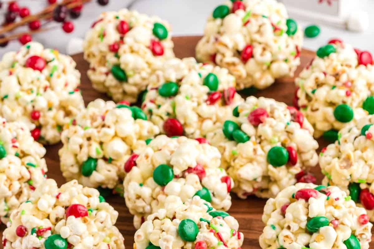 No-bake Christmas popcorn balls on a cutting board.