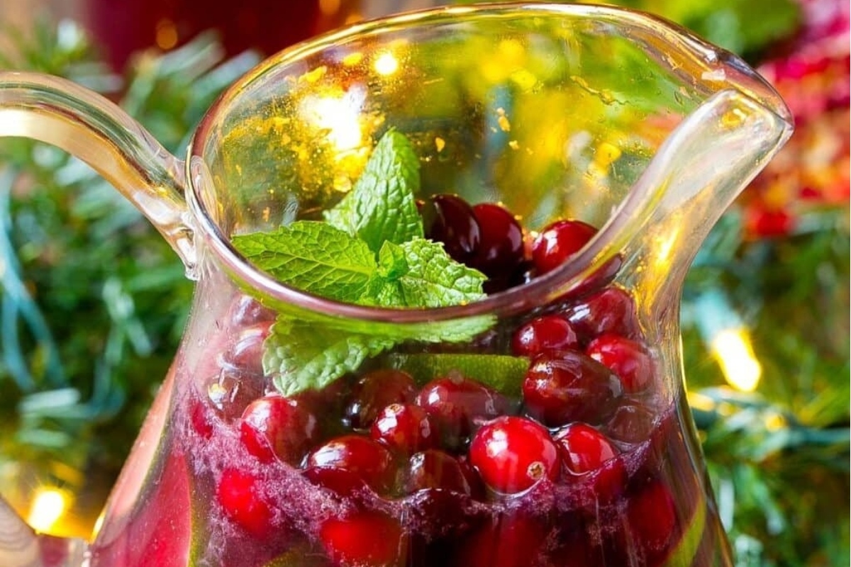 A refreshing pitcher of cranberry sangria infused with the invigorating flavor of mint leaves.