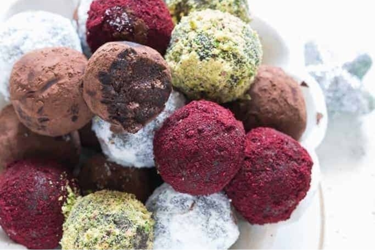 Chocolate truffles in a bowl on a white plate.