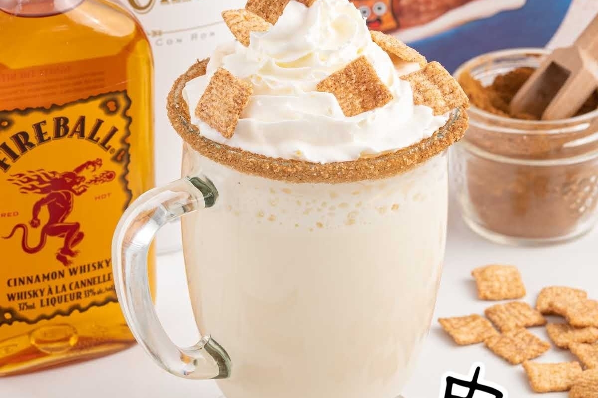 Indulge in the perfect Christmas cocktail with a mug of creamy delight topped with decadent whipped cream and a subtle hint of bourbon.