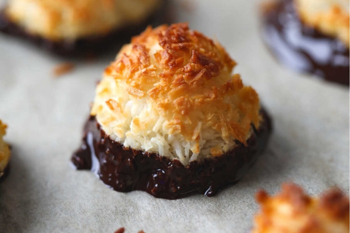 A freezable coconut macaroons with chocolate drizzled on top.