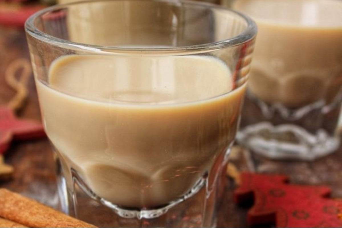 A shot of mulled wine in a glass with cinnamon sticks, perfect for cozy holiday gatherings.