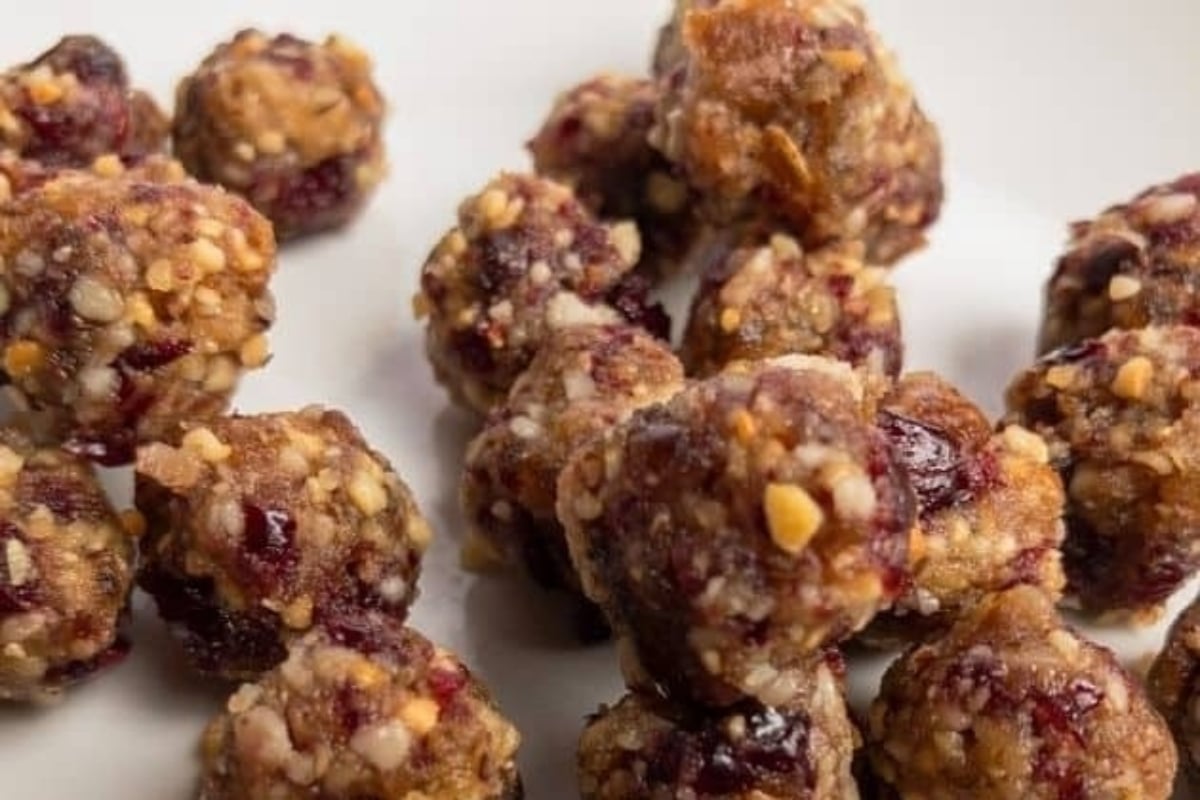 Cranberry protein balls on a white plate, perfect for cranberry snack recipes.