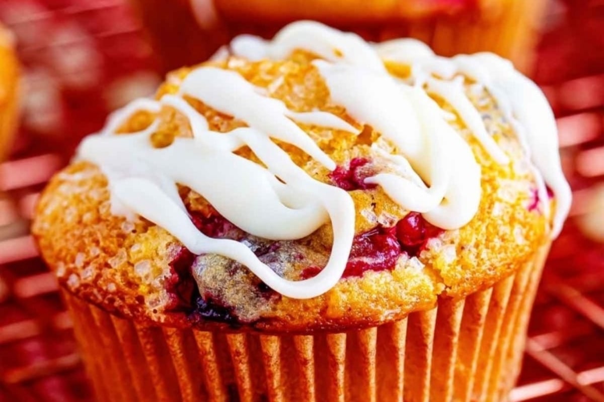 Title: Delicious Cranberry Muffins with a White Icing, Perfect for Snacking

Description: Indulge in the delightful goodness of cranberry muffins as they cool off on a rack