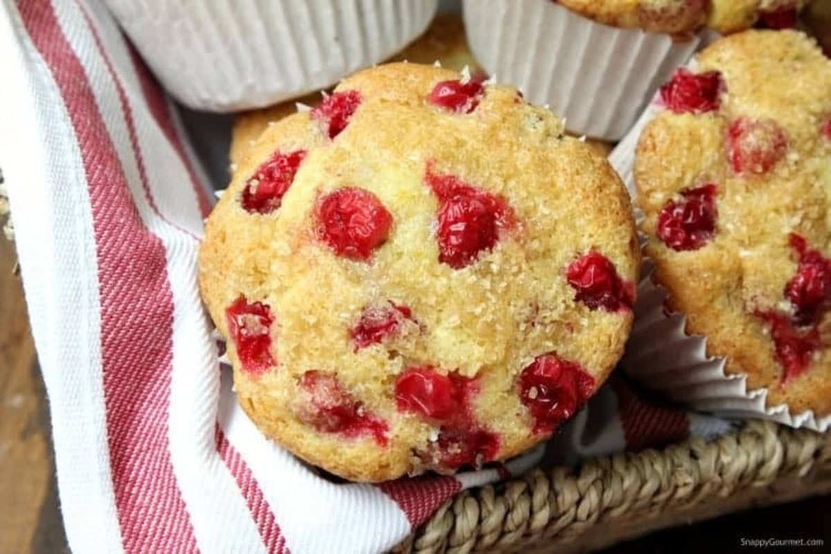 Cranberry muffins in a basket on a table, perfect for cranberry snack recipes.