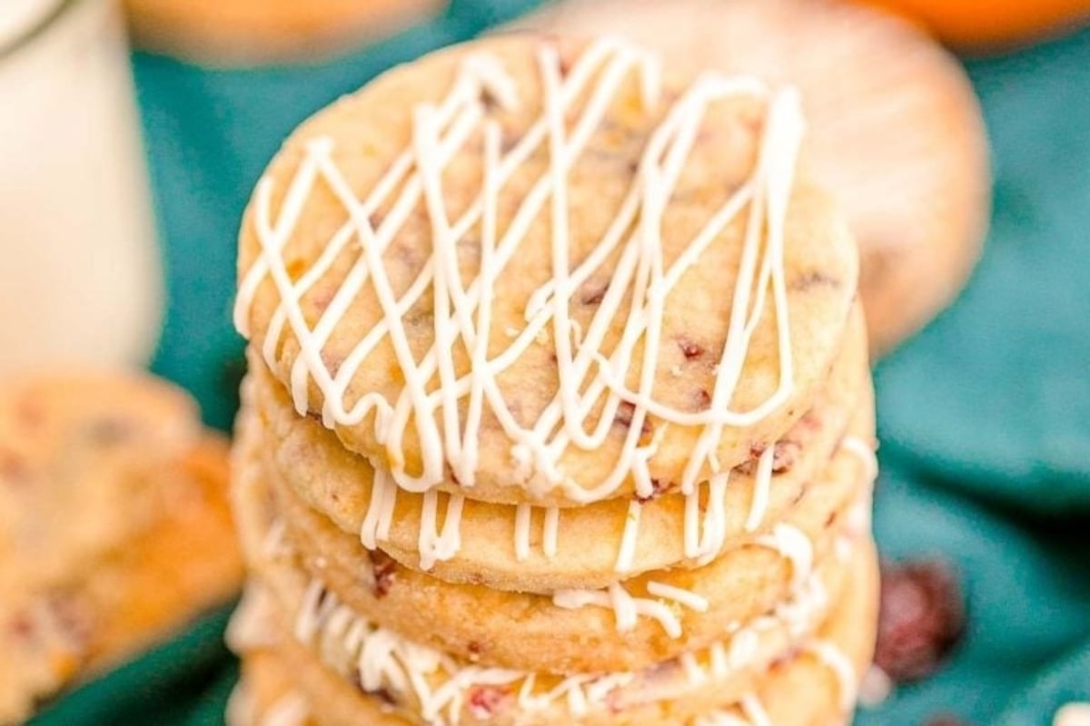 A stack of cranberry cookies with icing, perfect for freezing and enjoying later.