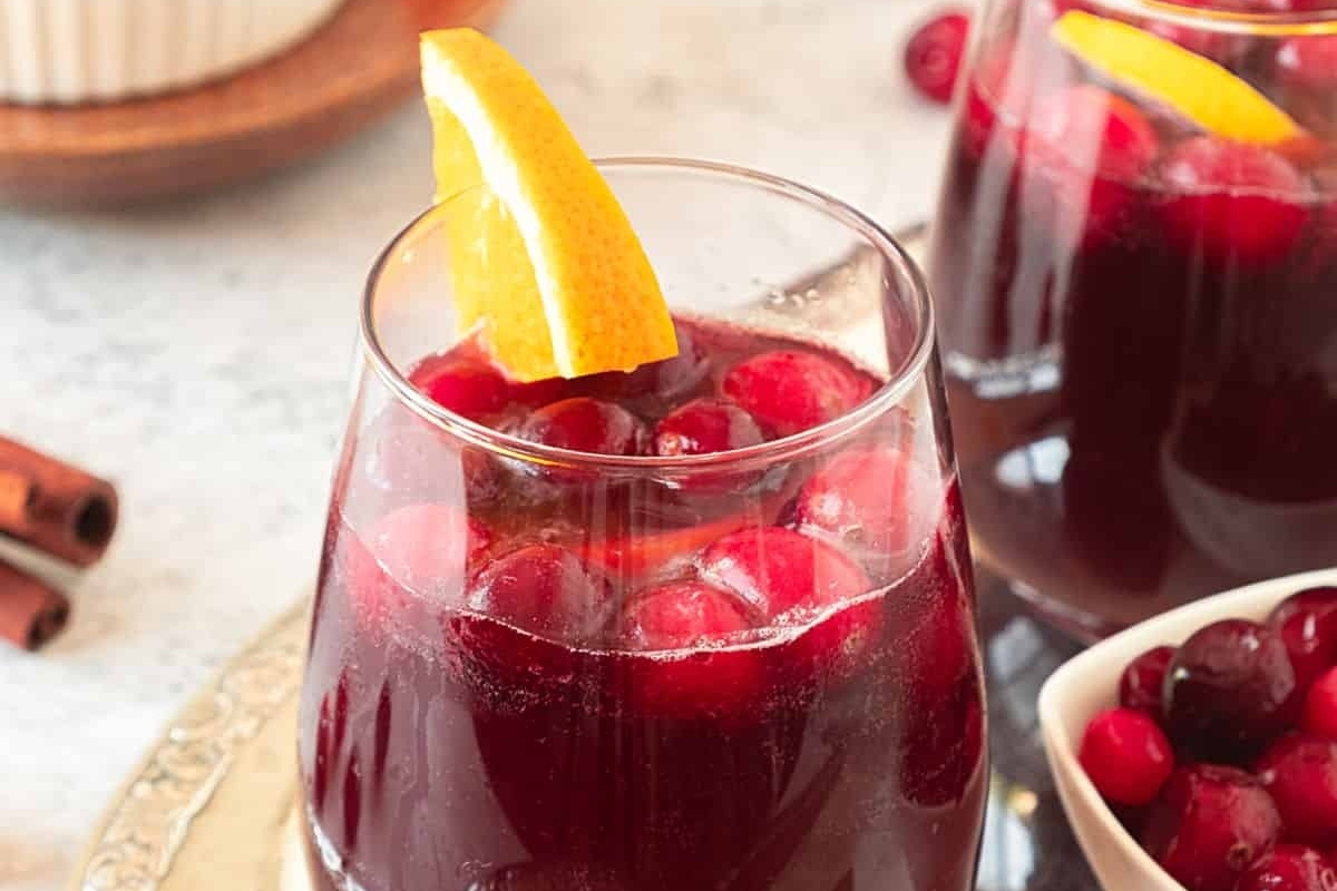Two glasses of cranberry sangria, perfect for your New Year's Eve cocktail ideas, beautifully presented on a tray.